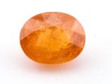an orange sapphire stone on a white background