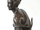 bronze statue of a woman with a bow and a book