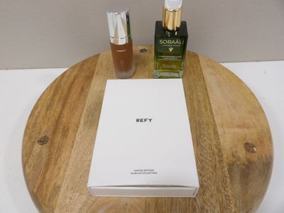 two bottles of perfume and a box on a wooden tray