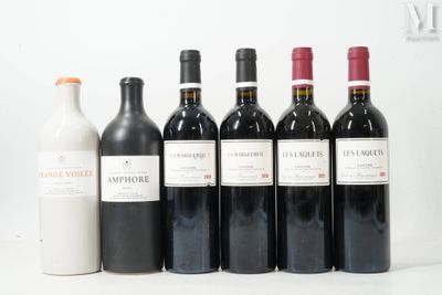 several bottles of wine are lined up on a white surface
