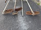 a bike that has been left on the street with two skis attached to it