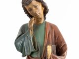 statue of a man holding a book and a glass of wine