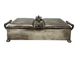 an antique silver plated box with writing on it