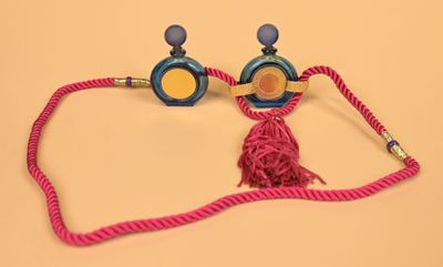 a pair of blue and yellow earphones on a pink cord