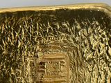 a gold bar that is sitting on top of a table