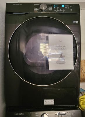 une machine à laver et un sèche-linge noirs placés l'un à côté de l'autre