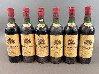 six bottles of wine are lined up in a row on a table
