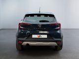 the rear end of a black car in a room with a white wall