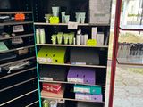 a display of beauty products in a store with a clock in the background