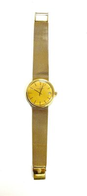 gold colored watch with yellow face on a white background