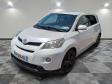 a picture of a white toyota yaris parked in a garage