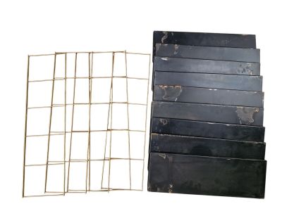 a stack of black boxes and a wire fence