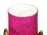 a close up of a pink vase with a gold rim