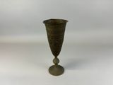 an image of a metal vase sitting on top of a white surface