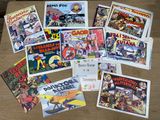 a lot of comic books on a wooden table