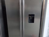 a silver refrigerator and a white refrigerator freezer next to each other