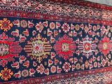 rug on the floor is blue and red with a pattern on it