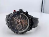 a close up of a watch on a white surface