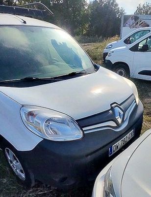 a white van that is parked next to a white van