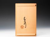 a small wooden box with a japanese writing on it