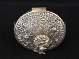 an antique silver purse with a flower design on the front