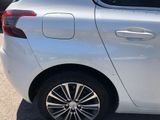 a white car parked in a parking lot with other cars in the background