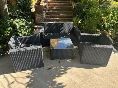 an image of a patio setting with a coffee table and chairs