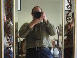 a man taking a picture of himself in a mirror