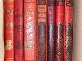 many books in a box that are sitting on a shelf