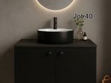 Le meuble de salle de bains est surmonté d'un miroir rond et d'un lavabo noir.
