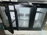 a refrigerator with two glass doors open in a room