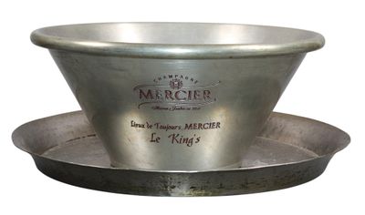 a metal bowl that is sitting on top of a saucer
