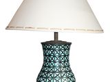 a lamp that is sitting on a table with a shade on it