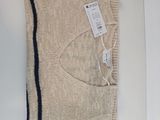 an image of a sweater with a tag on it sitting on a table