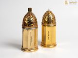 pair of gold plated salt and pepper shakers on a white surface