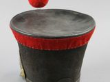a small hat with a red pom pom on it