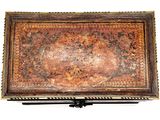 an old wooden box with a floral design on it