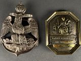 an image of a silver medal with an eagle on it and a medal with a crown on it