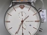 an image of a silver and gold watch with a tag on it