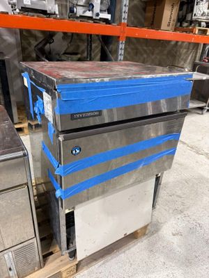 a blue box sitting on top of a pallet in a warehouse
