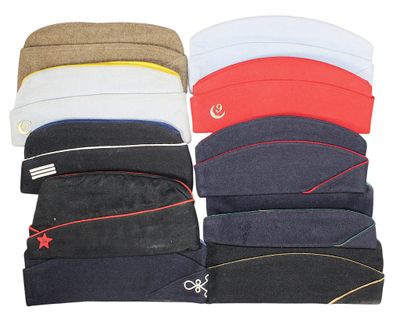 several hats are stacked on top of each other on a white surface