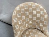 a chair that is sitting on the floor next to a pillow