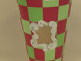 a cup with a red and green checkered pattern on it