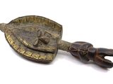 a wooden spoon with a metal handle and a wooden spoon in the shape of a turtle