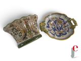 two pieces of pottery that are sitting on a table