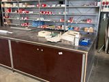 a large counter in the middle of a room with many shelves