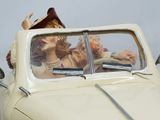 a figurine of a woman and a man in a car