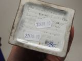 someone is holding a small white plate with numbers on it