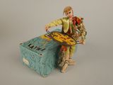 a figurine of a man holding a tray of food