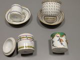 several cups and saucers sitting on top of a table